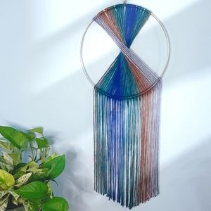 Handmade yarn tapestry hung on brass ring